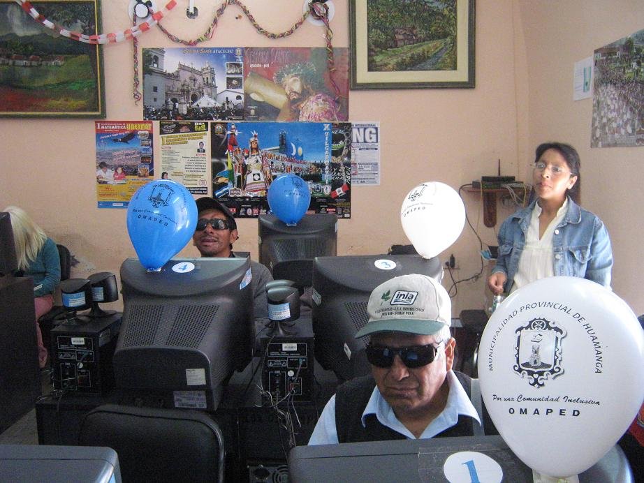 Foto de personas invidentes utilizando computadoras durante capacitaciones en informática.